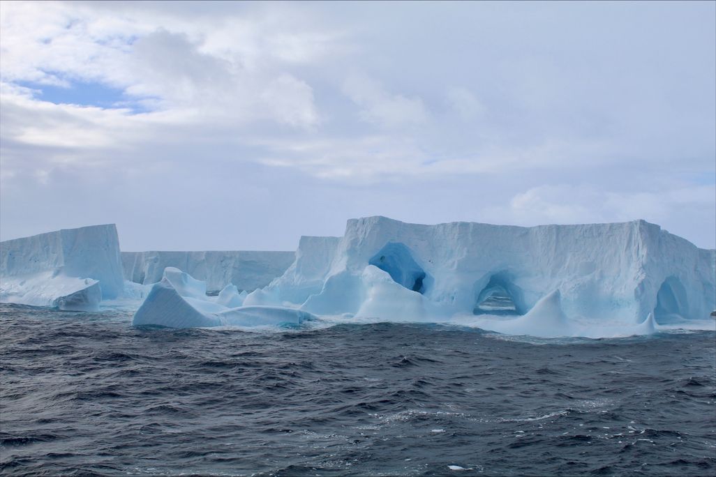 Blue iceberg floating on the water