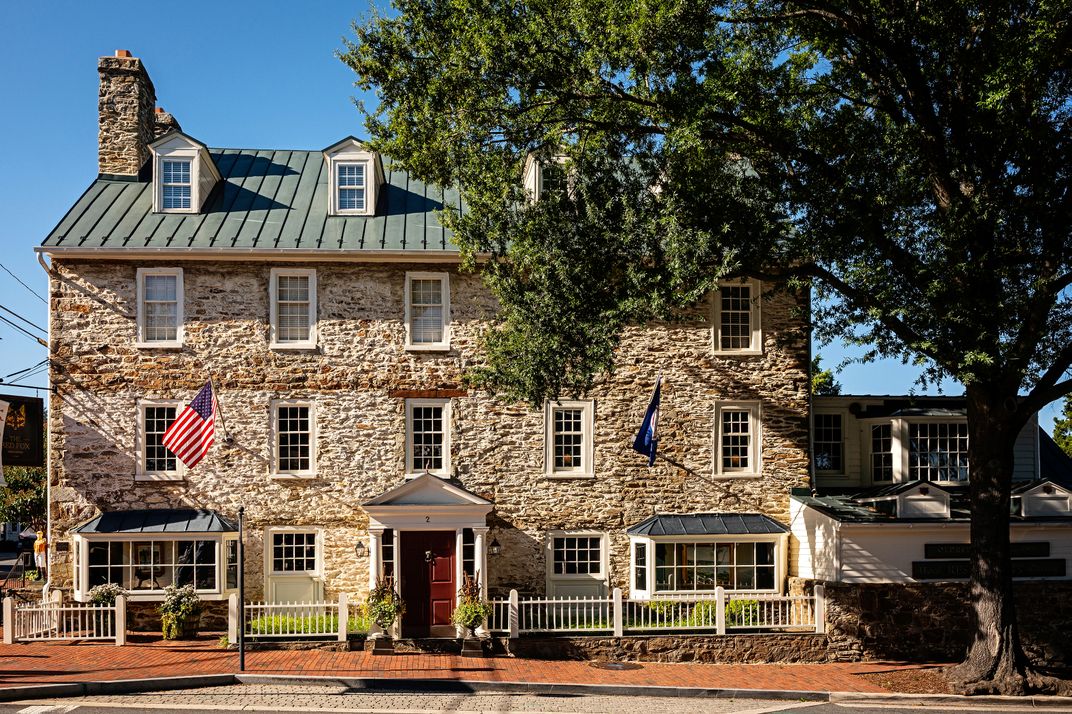 The sturdy façade of the Red Fox Inn & Tavern in Middleburg, Virginia, dates to 1728. Under a different name, the establishment served as a field hospital during the Gettysburg Campaign of the Civil War, and in the next century hosted Jacqueline Kennedy O