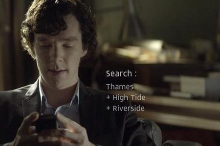 Benedict Cumberbatch as Sherlock Holmes searching for clues on his mobile phone