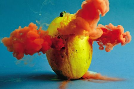 A spaghetti squash explodes with color. Maciek Jasik does not reveal his technique for making produce expel colorful smoke.