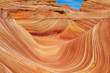 A stunning landscape featuring a wavy sandstone rock formation
