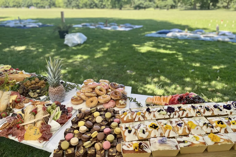 Picnic Grazing Table with picnic in background_credit The Luxury Picnic Company.jpg