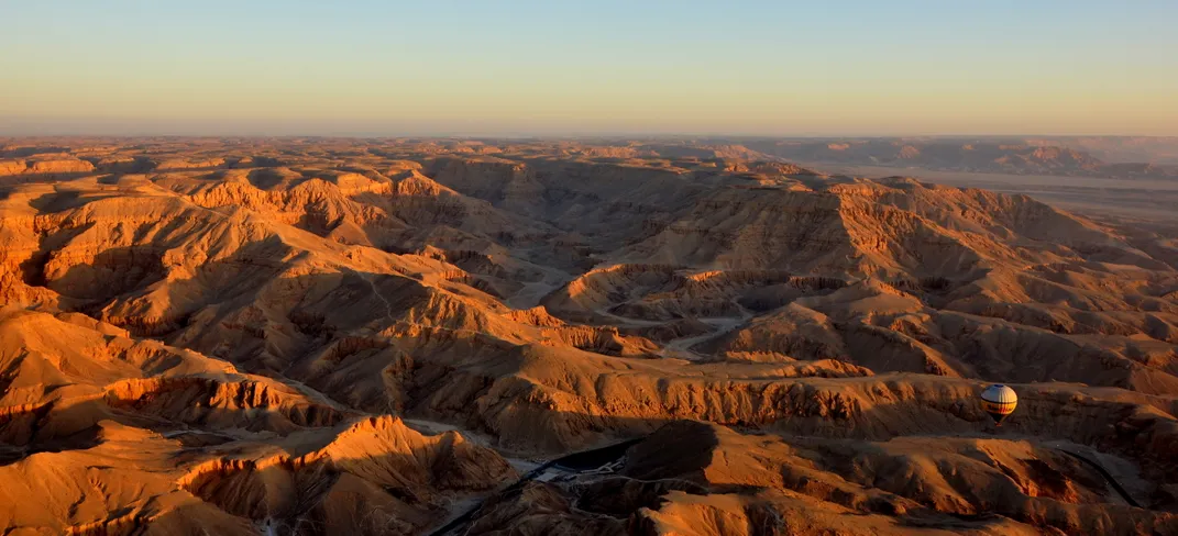 6 - Passengers in a hot-air balloon soar over the west bank of the Nile and the Valley of the Kings while the sun sets.