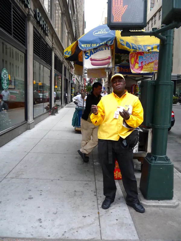 Nigerian man eating hot dog in New York City thumbnail