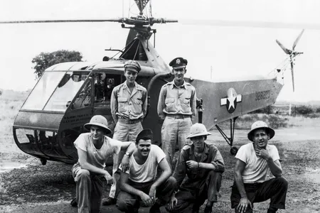 In eastern India in 1944, Carter Harman (standing, left, next to his co-pilot) had the extremely rare job of helicopter pilot.The maintainers with him, members of the 1st Air Commando group, were among the first to service helicopters in the field.