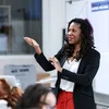 Summer Hamilton stands in front of a classroom gesturing.