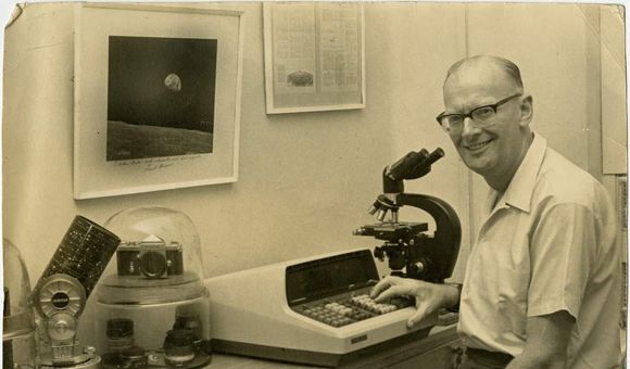 Arthur C. Clarke poses for a photo while he sits at his desk, circa 1969.