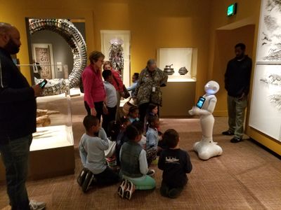 Pepper talks to a group of museum visitors on the lower level of the National Museum of African Art. 