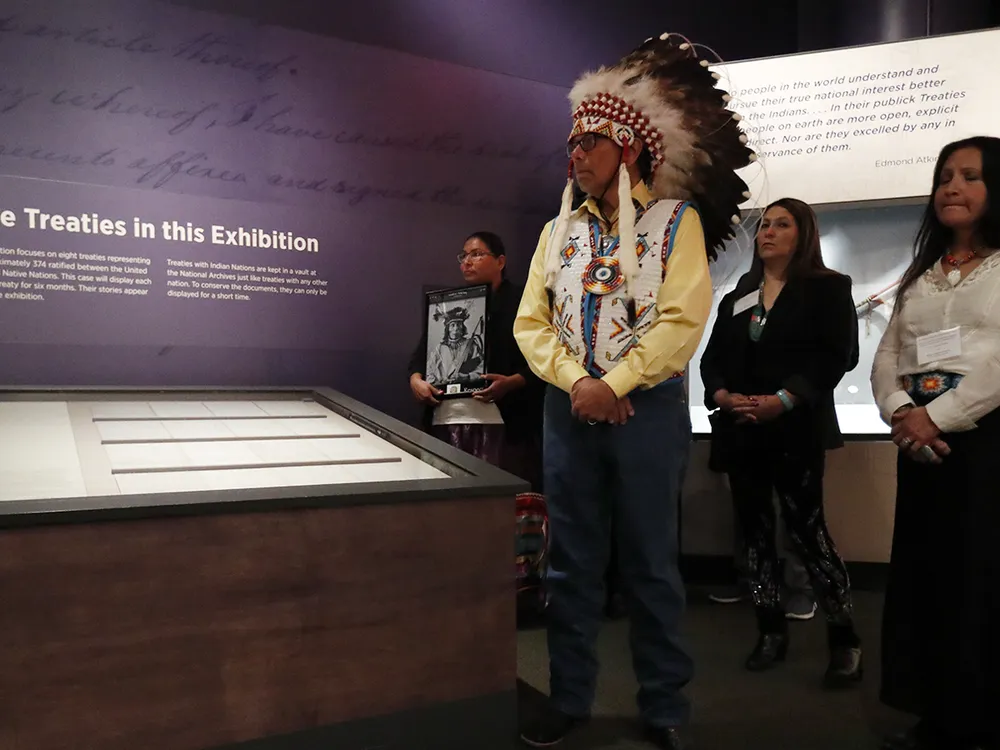 Ramey Growing Thunder (Fort Peck Sioux and Assiniboine Tribes), Chief John Spotted Tail (Rosebud Sioux Tribe), Carolyn Brugh (Fort Peck Sioux and Assiniboine Tribes), and Tamara Stands and Looks Back–Spotted Tail (Rosebud Sioux Tribe) take part in a ceremony at the National Museum of the American Indian honoring the Treaty of Fort Laramie. Ms. Growing Thunder holds a photograph of Medicine Bear (Yanktonai Band of Sioux), one of the Native leaders who signed the treaty 150 years ago. Delegations from the Yankton Sioux Tribe, Oglala Sioux Tribe, and Northern Arapaho Tribe also traveled to Washington, D.C., for the installation of the treaty in the exhibition