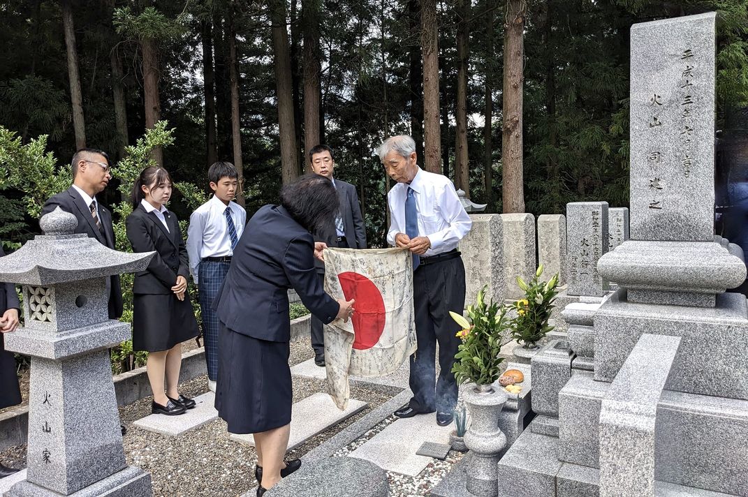 Tsukasa Hiyama at his mother's grave