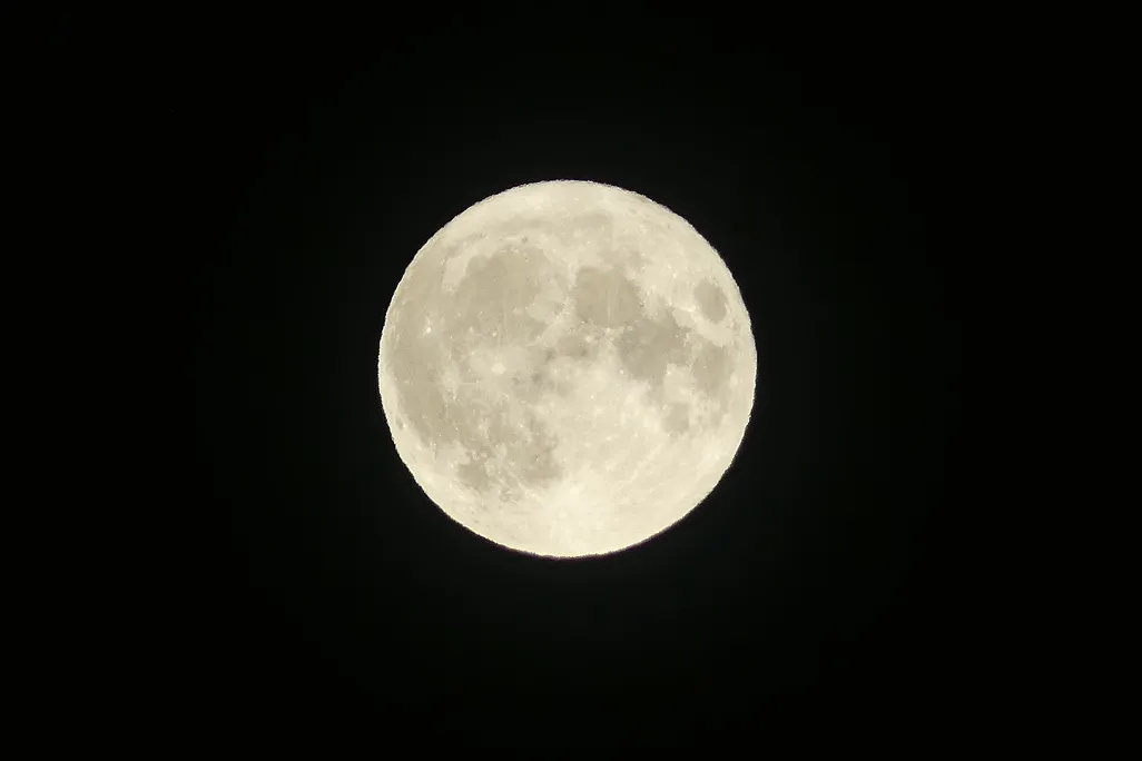 A full moon in a dark sky