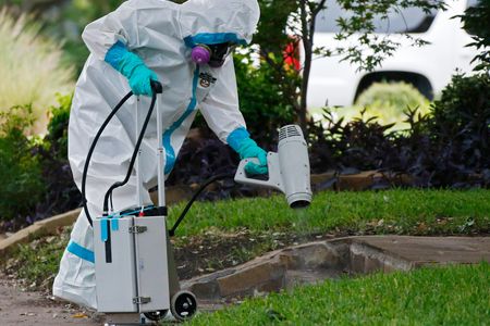 A hazmat crew cleans the steps outside the Dallas apartment of a health care worker who tested positive for Ebola.