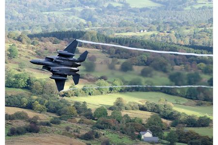 Dave Tripp 
FINALIST: Military Category
USAF F-15 turning hard in WalesSnowdonia National Park, Wales &bull; Photographed October 2012
"This photograph was taken on my first visit to The Mach Loop," says Tripp, "where low-level flying is practiced by NATO air forces. [Aircraft fly] 500 knots at 500 feet—or less."
