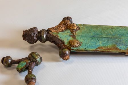 The shorter sword was decorated with polished gems, two of which were carved with swastikas.