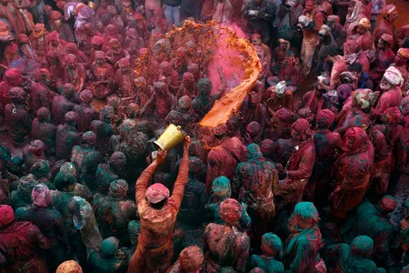 A man throws colored water as he celebrates Holi in Nandgaon, in the northern Indian state of Uttar Pradesh, February 28, 2015.