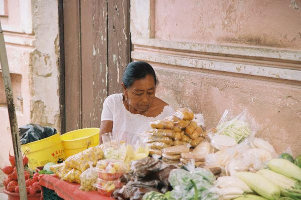 A sweet lady selling some vegetable on the side of the road in Valladolid, Yucatan, Mexico. thumbnail