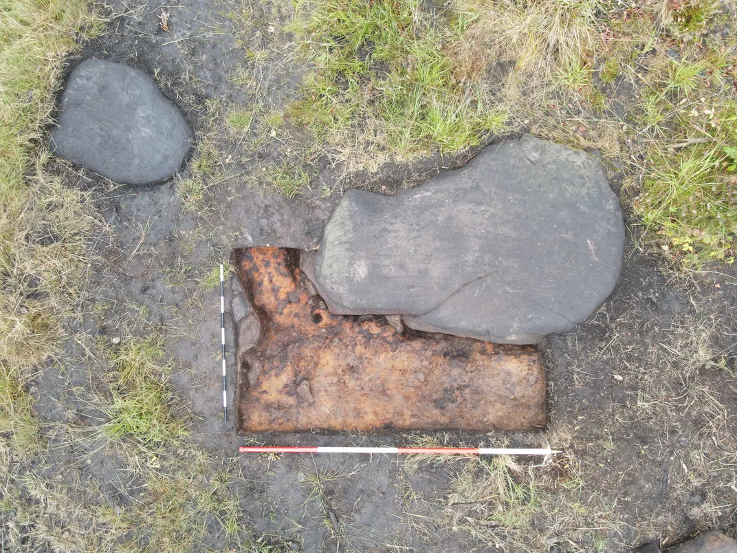 Overhead view of two stones near some grass