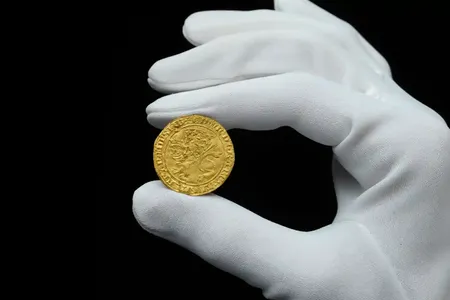 A 14th-century gold coin found by a metal detectorist in England sold for $185,000 at auction on Tuesday.