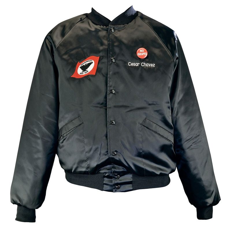 Black leather jacket decorated on the right breast with the symbol of the United Farm Workers. The name "Cesar Chavez" is written on the left breast