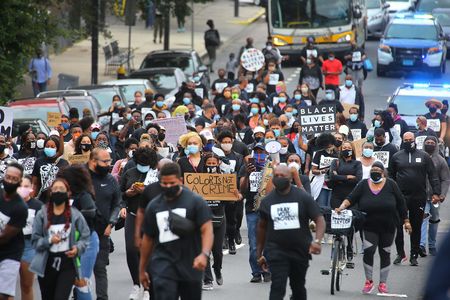 In Boston's Mattapan on August 15, 2020, protesters march from Jubilee Christian Church to protest police brutality, systemic racism and other oppressive systems unfavorable to Black and Brown people.