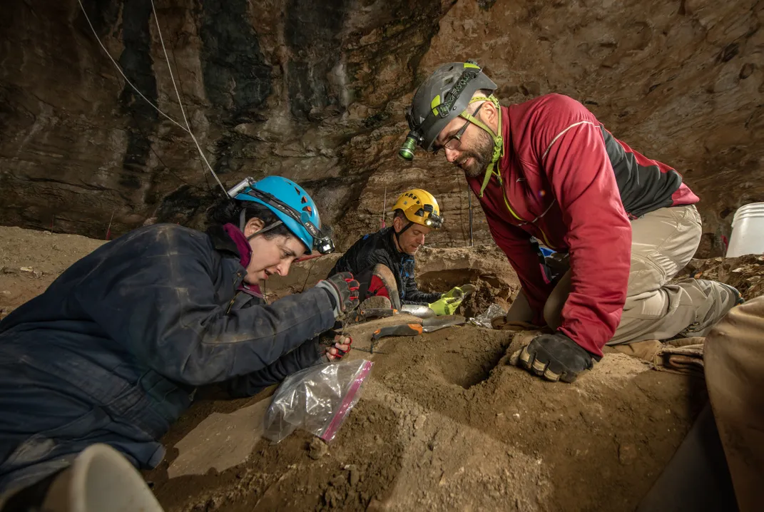 Meachen assists John Jacisin, a paleontologist and herpetologist at the University of Wisconsin-Green Bay, in examining a fossil find before sealing it in a bag and sending it to the surface