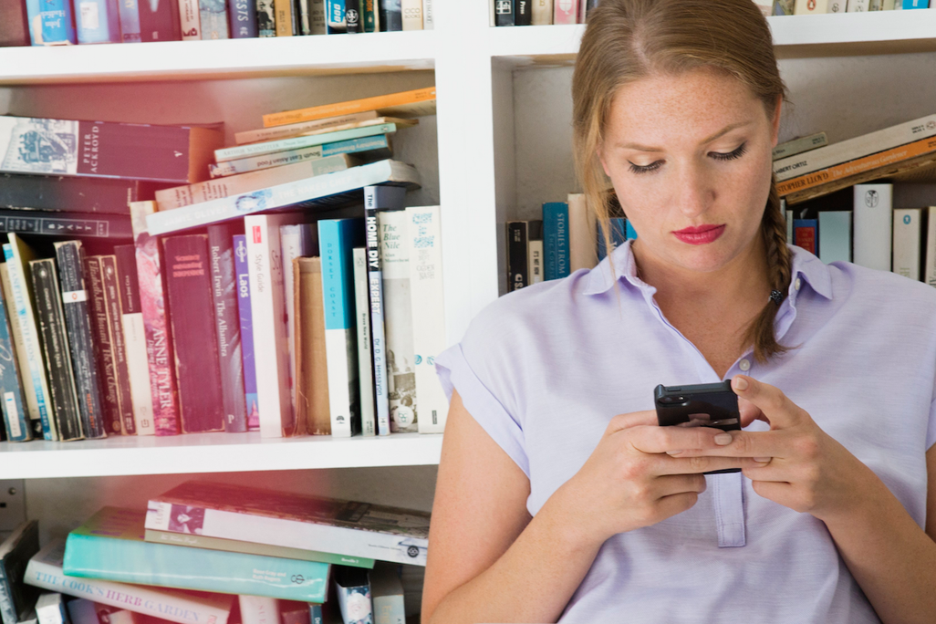 Woman Texting in Library