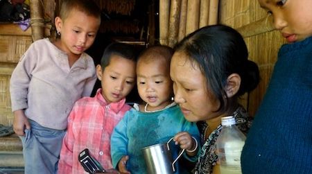 An Indian woman and her children from KajÃµ, a village in the East Kameng District, Arunachal Pradesh, India, listen to a recording of a song in Koro. The Tibeto-Burman language is considered endangered.