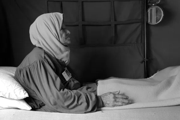 The mother of Ahmad sits on the bed at the tent of the victims of enforced disappearance and the missing, Beirut, 2010 thumbnail
