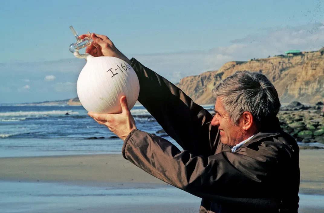 Keeling himself samples air with flask I-166 near La Jolla, California.
