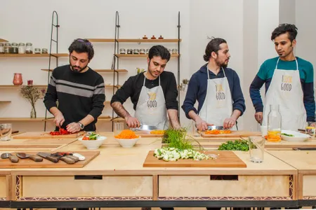 Some of Uber den Tellerrand's volunteers teaching a cooking class.