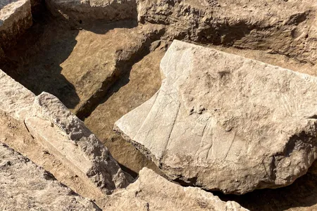Researchers found the stone slab broken and buried in an ancient throne room.