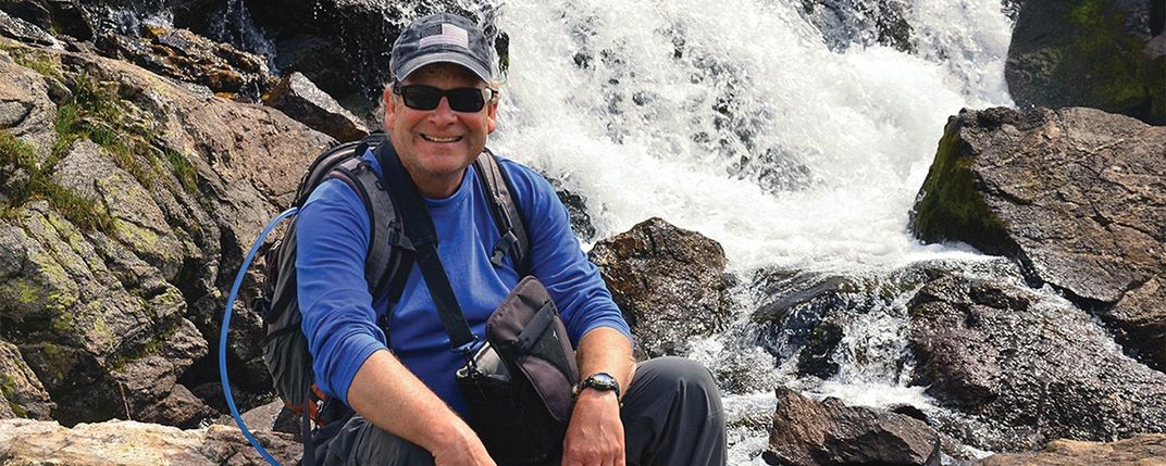 George Sowers in front of a waterfall