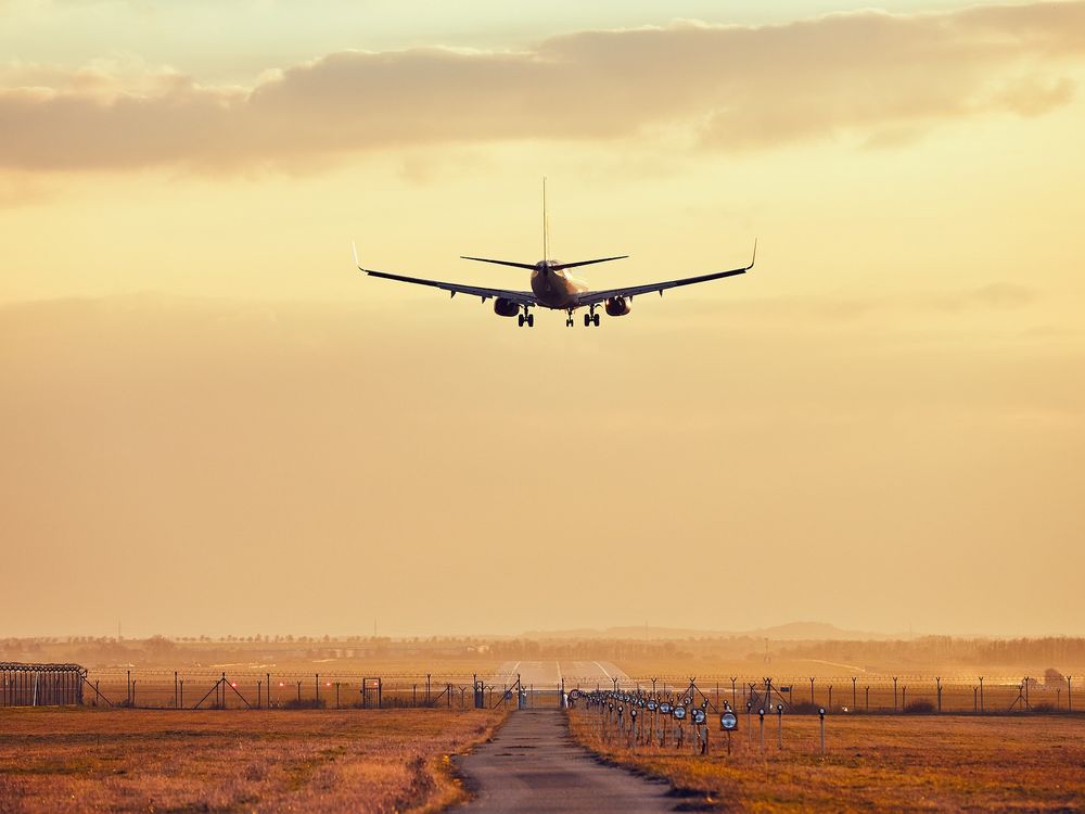 Airplane flying into sunset