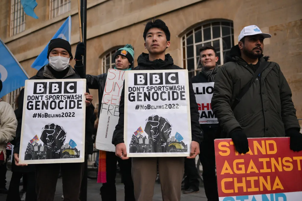 Activists in London hold signs urging the BBC to boycott the 2022 Olympic Games in Beijing