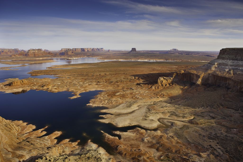 Arial image over lake powell with red rock formations and low water levels