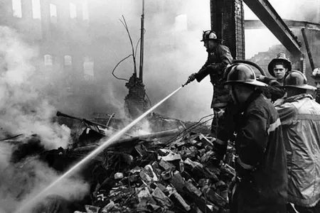 Fire fighters attempt to douse a smoldering building on Superior following the shootout in the Glenville neighborhood of Cleveland on July 23, 1968. 