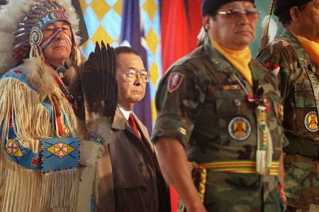 Dressed in ceremonial regalia, Senator Ben Nighthorse Campbell (Northern Cheyenne), a veteran of the Korean War, stands with World War II veteran Senator Daniel K. Inouye and Native American veterans of the Vietnam War during the opening of the National Museum of the American Indian on the National Mall. October 21, 2004, Washington, D.C.