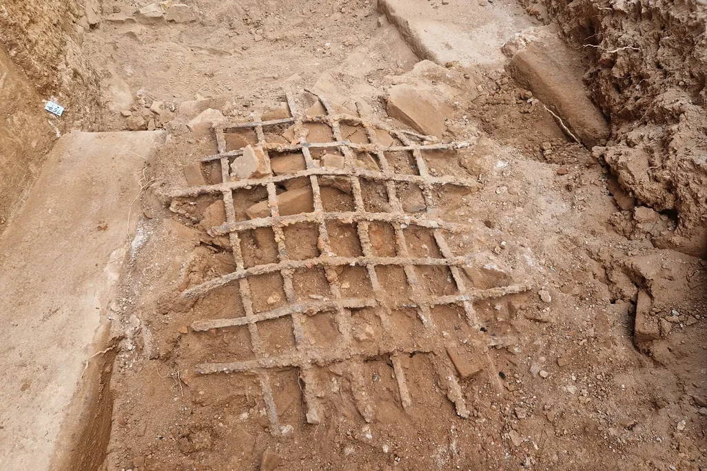Iron bars covered in dirt on the ground