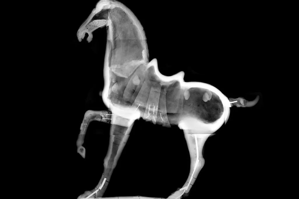 black and white horse sculpture with one foot raised