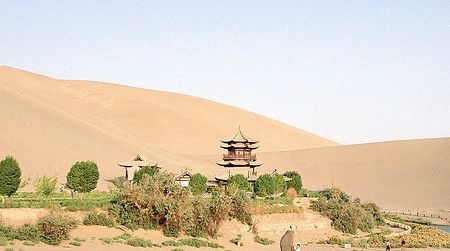 Tourists explore the Crescent Moon Spring along the historic Silk Road trade route.