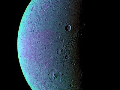 The leading hemisphere of Dione shows tectonic faults running across its surface, along with craters, in false color, which was produced by an image in the ultraviolet, green, and infrared wavelengths taken by the Cassini Orbiter. The subtle variations in color may be caused by fine ice particles. 