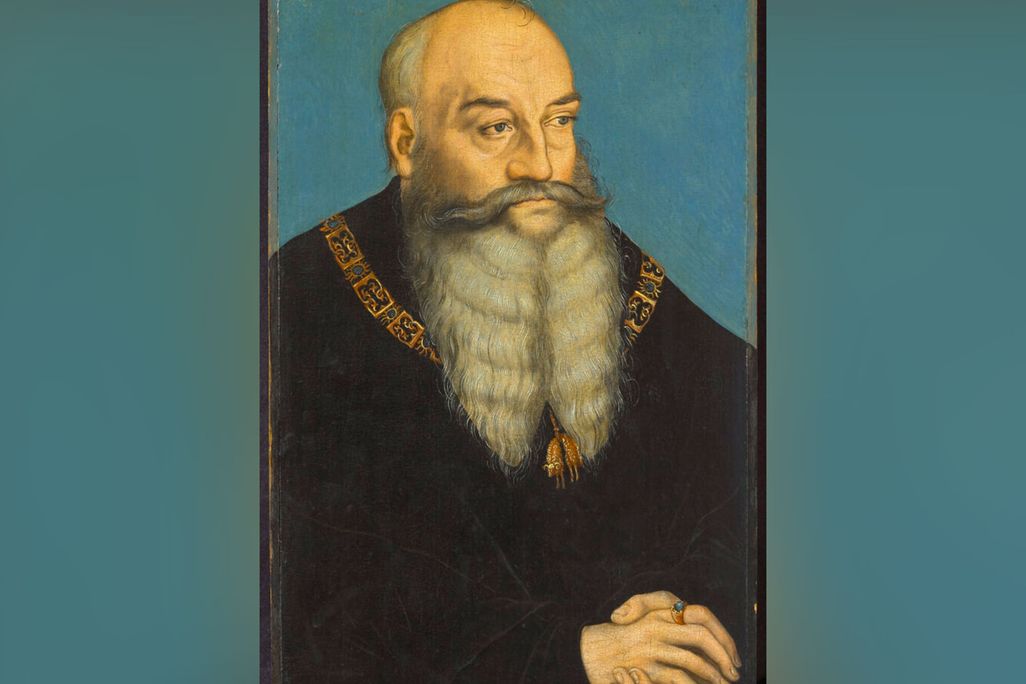 Painting of a man with a long beard wearing black robes with his hands folded in front of him