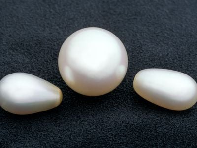 Smooth pearls in the shape of orbs and ovals are usually created by bivalves, like mussels, in pearl farms. As with all gems, the less blemishes they have, the more valuable they are. (Chip Clark, Smithsonian)