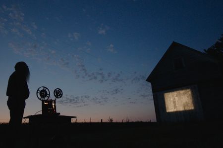  In a still from the documentary, Michael Zahs screens one of the early films against a barn in Iowa.