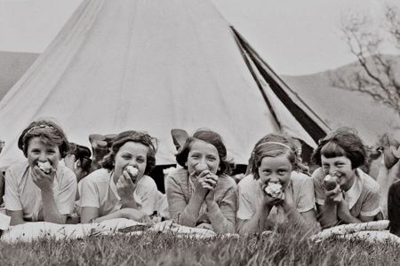 Girls eating apples on a field in Castleton, Derbyshire on May 26, 1937.