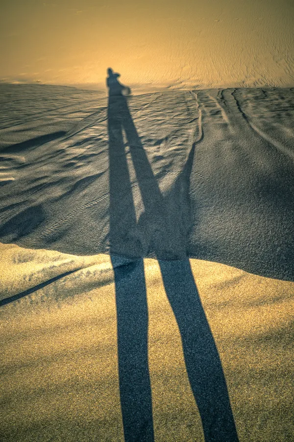 Growing shadow in the sand dune thumbnail