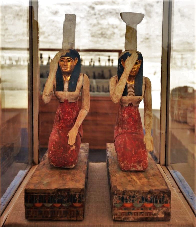 Two statues of kneeling women