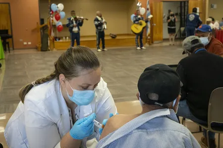 A pharmacist delivers a Covid-19 booster shot in Chicago during a clinic for seniors.