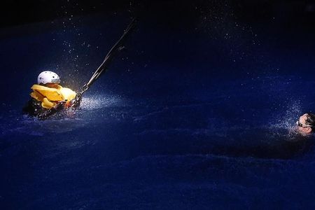 A student practices a sling lift in the darkened pool at Survival Systems USA in Groton, Connecticut. Passengers who take an underwater escape training class—even for a day—can as much as triple their odds of surviving a helicopter crash. 