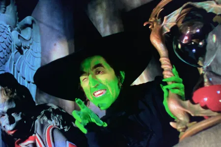 The Wicked Witch of the West, played by Margaret Hamilton, holding the hourglass